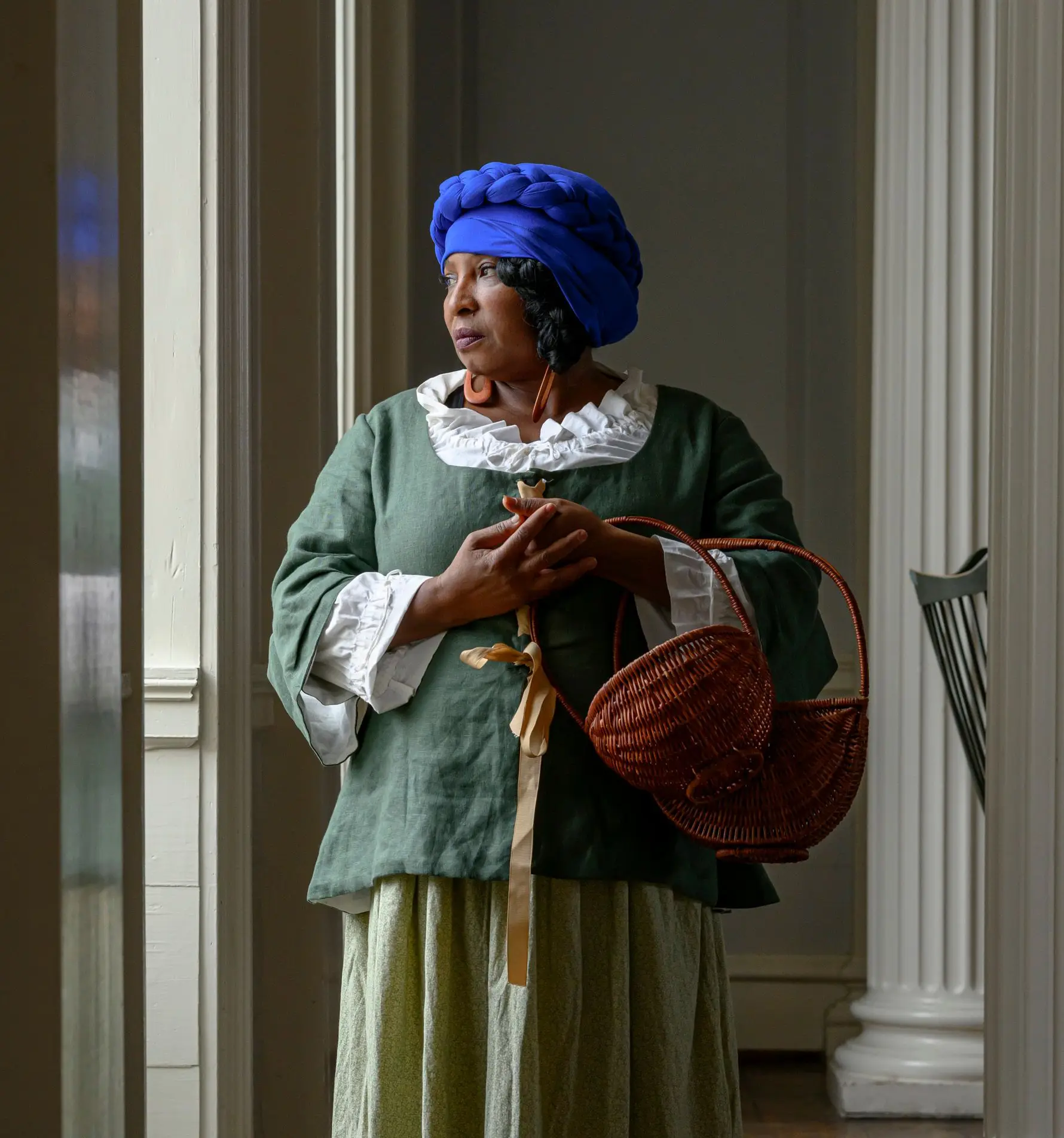 African American woman, dressed in era appropriate clothing.