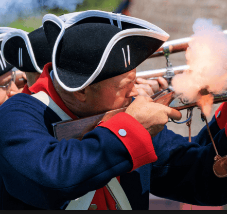 Reenactor firing a musket during a Revolutionary War event in South Carolina.